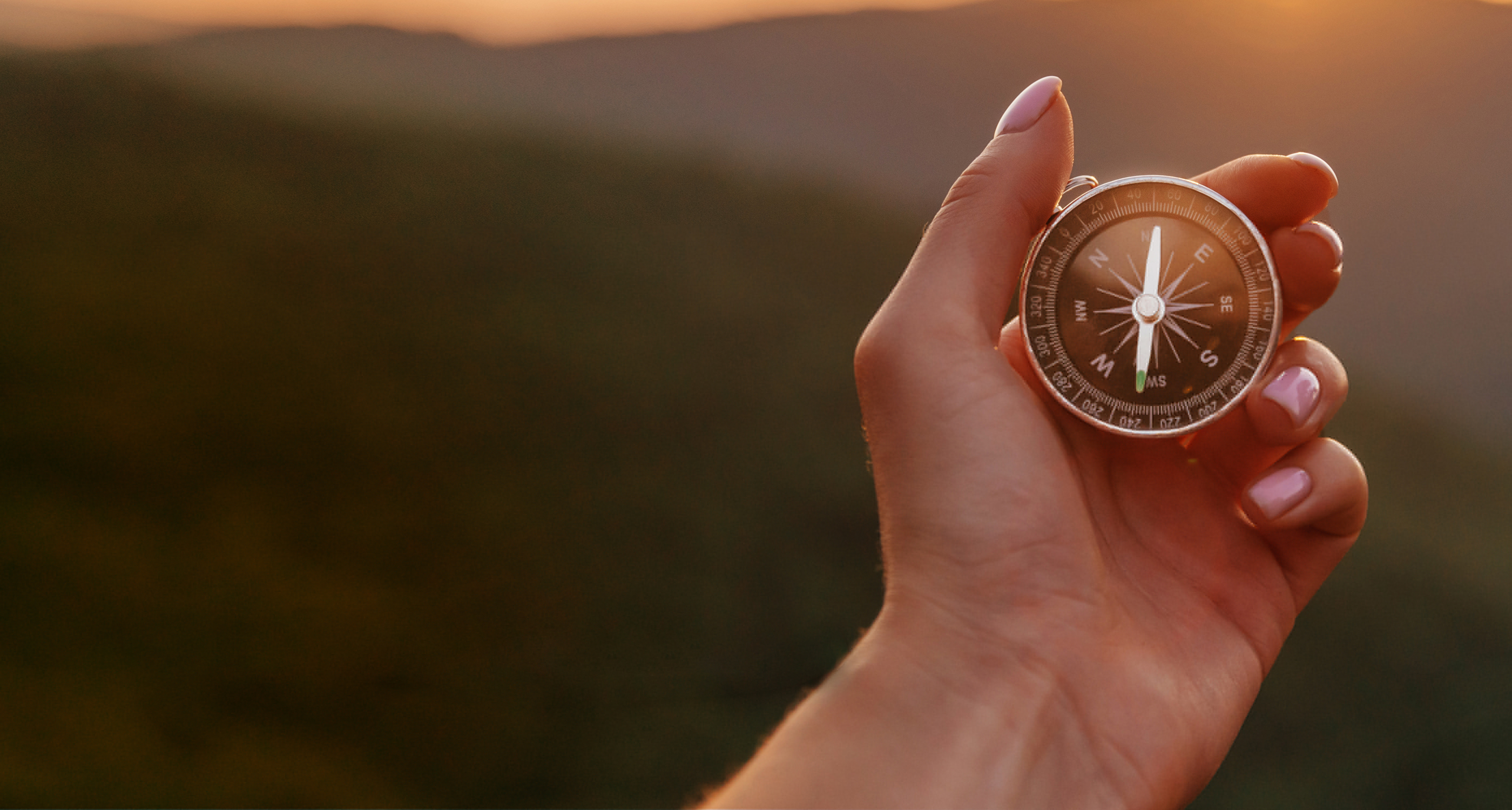 Traveler hand holds a compass